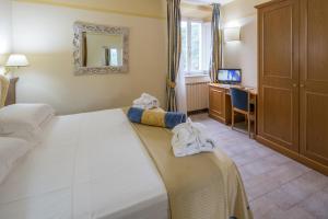 Postel nebo postele na pokoji v ubytování Hotel & Terme Bagni di Lucca