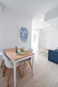 a dining table and chairs in a living room at Letmalaga Andalucia in Málaga