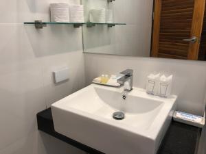 a white sink in a bathroom with a mirror at Crystal Lamai Hotel in Lamai