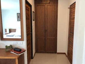 a hallway with a wooden door and a mirror at Crystal Lamai Hotel in Lamai