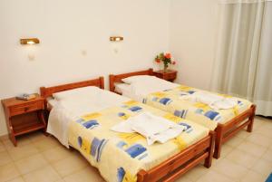 two beds sitting next to each other in a room at Villa Phoenix in Laganas
