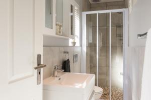 a bathroom with a sink and a toilet and a shower at Suburban Bliss Durbanville in Kraaifontein +25 photos