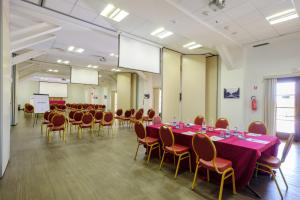 a conference room with a long table and chairs at Poggio all'Agnello Sport & Family Holidays in Populonia +37 photos