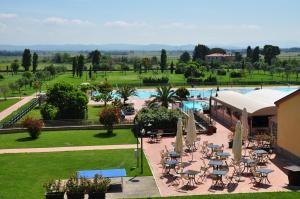 a resort with a pool and tables and chairs at Poggio all'Agnello Sport & Family Holidays in Populonia