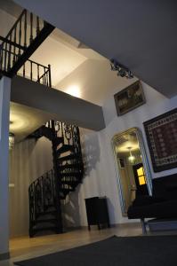 a room with a spiral staircase and a mirror at Apartament Serce Miasta | The Heart of the City in Suwałki