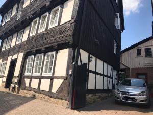 a car parked in front of a building at Ackerbürgerhaus von 1604 in Goslar