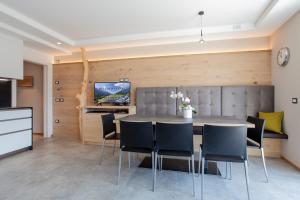 a kitchen and dining room with a table and chairs at Bellavista - Lake in Molveno