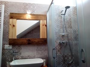 a bathroom with a mirror and a toilet and a shower at Cortile Calinea in Castrignano del Capo +38 photos