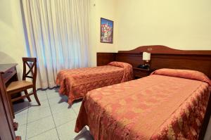 Letto o letti in una camera di Hotel Pavone