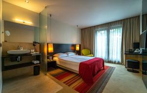 Postel nebo postele na pokoji v ubytování mOdus Hotel