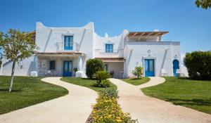 a white house with blue doors and a walkway at VOI Marsa Siclà Essentia in Sampieri