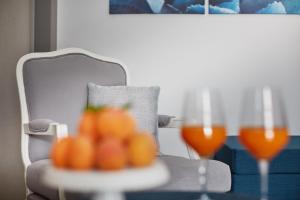 a table with two glasses of orange juice on it at VOI Marsa Siclà Essentia in Sampieri