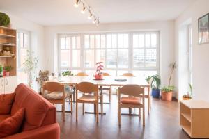 a living room with a table and chairs at myNext - Riverside Hotel Salzburg in Salzburg