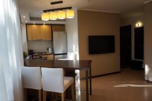 a kitchen with a table and chairs and a refrigerator at apartment 22 in Riga