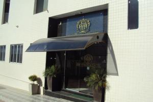 a entrance to a building with a blue awning at Araripina Palace Hotel in Araripina