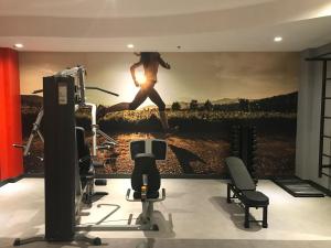 a room with a painting of a woman running on a wall at ibis Caxias do Sul in Caxias do Sul