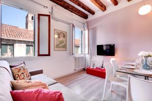 a living room with a couch and a table at Botteri Palace Apartments in Venice