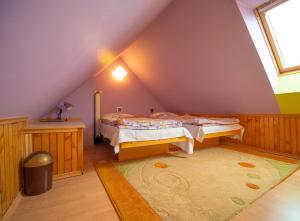 A bed or beds in a room at Penzión Skitour