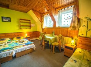 A bed or beds in a room at Penzión Skitour