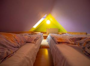 A bed or beds in a room at Penzión Skitour