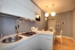 a kitchen with a sink and a stove at Botteri Palace Apartments in Venice