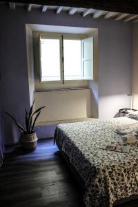 a bedroom with a bed and a window at LuccaStay 18 in Lucca
