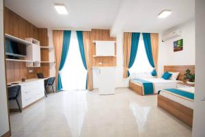 a bedroom with a bed and a desk and a bed and a desk at Greenland Premium Residance in Lefkosa Turk