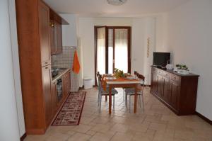 a kitchen with a table and a dining room at Casa dei girasoli in Perugia