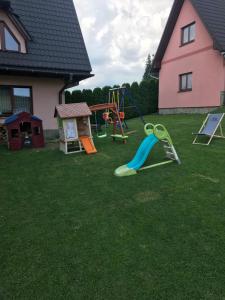 a yard with a playground with a slide at Pokoje u Borzana in Biały Dunajec +56 photos