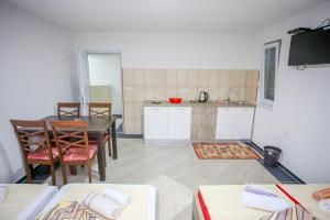 a kitchen and dining room with a table and chairs at Apartments River Una 4 in Bihać