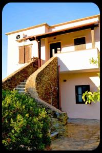 a house with a staircase leading up to a building at Casa "Il Girasole" in Stintino