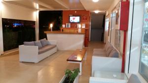 a living room with two couches and a bar at Apartamentos Vista al Puerto in San Antonio Bay