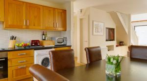 a kitchen with a table with chairs and a microwave at Self Catering Holiday Homes Killarney Town Centre in Killarney