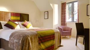 a hotel room with a bed and a chair at Great Southern Killarney Holiday Homes in Killarney