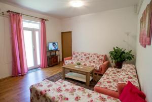 a living room with two couches and a table at Apartman Oaza in Trebinje