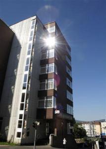 a tall building with the sun shining on it at Hotel Liberec in Liberec