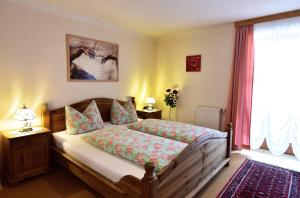 a bedroom with a bed and a large window at Ferienwohnungen Bloier in Bad Birnbach