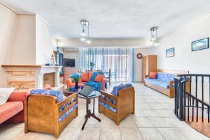 a living room with two couches and a table at Indigo Zante Home in Zakynthos