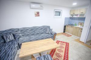 a living room with a couch and a table at Villa River Una 6 in Bihać
