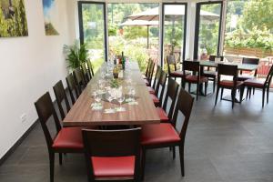 a dining room with a long wooden table and chairs at Weinhaus Thomas in Klotten