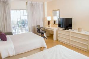 TV a/nebo společenská místnost v ubytování iStay Hotel Ciudad Juarez