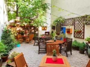 an outdoor patio with tables and chairs and plants at Explorer B&B Old Town Rooms & Apartment #don't be a tourist, be an Explorer! in Poznań