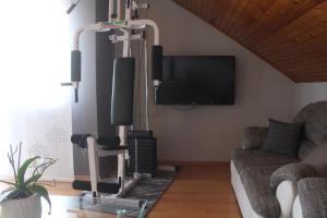 a living room with a flat screen tv and a couch at Apartman Ivana in Varaždin