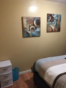 a bedroom with a painting on the wall at Economy Guest Village in Rock Springs