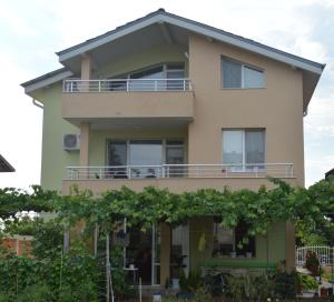 a house with trees in front of it at Yanis in Chernomorets