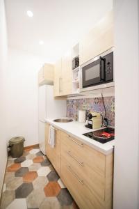 a kitchen with a sink and a stove top oven at Di Palma Suite in Naples