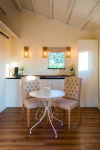 a kitchen with a table and two chairs at La Vie en Rose - a fully equipped pet friendly contactless house with fenced garden between the fields in Torhout