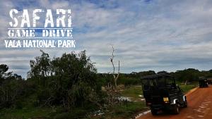 a jeep driving down a dirt road at Kottamba Yala Stay & Safari in Tissamaharama