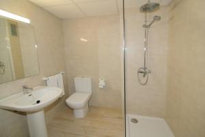 a bathroom with a shower and a toilet and a sink at Sunside Ibiza Studios - Only Adults- Formerly known as Central Park in San Antonio