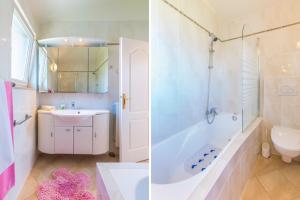 a bathroom with a tub and a sink and a toilet at Apartments Lucie in Premantura +39 photos